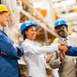 warehouse manager shaking hands with warehouse worker