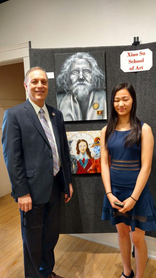 Biggs with Karina Yang, whose acrylic paint portrait, "Pride and Sorrow," took first place in the competition